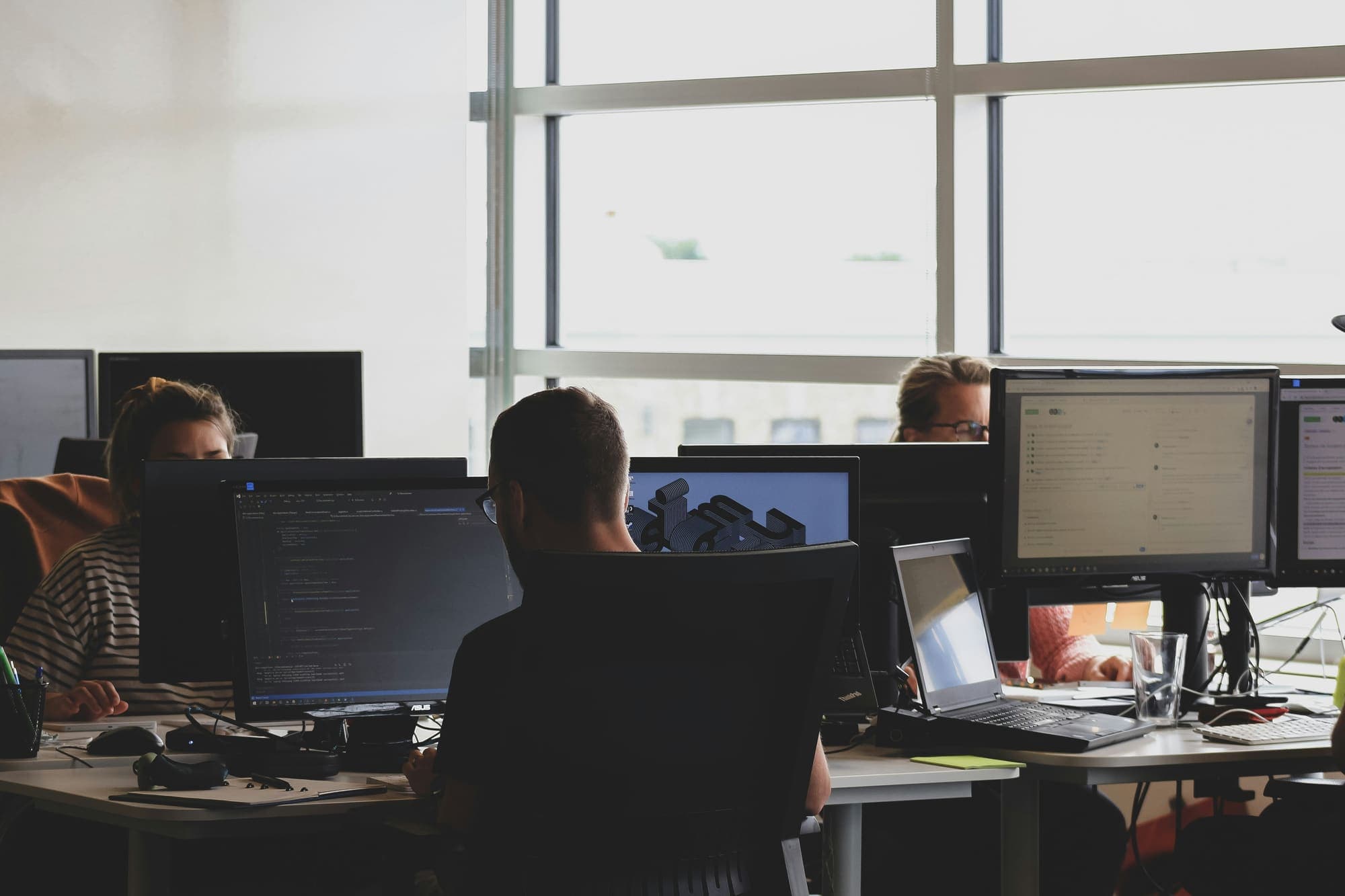 Engineers at their desks in a bright office