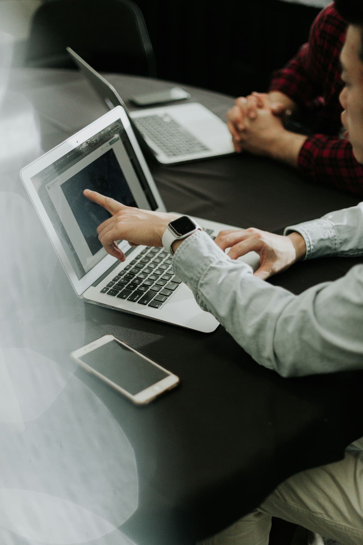 Two people reviewing work on a laptop